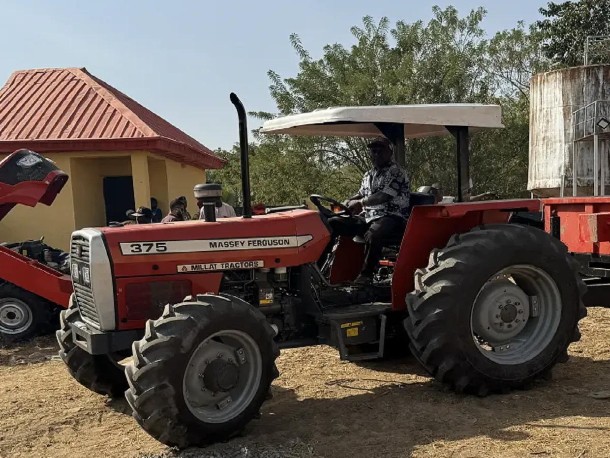 MF 375 tractor working with field implement
